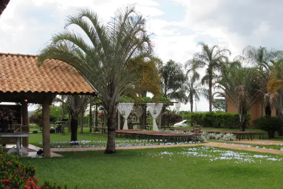 Quiosque de madeira com telhado de barro no gramado